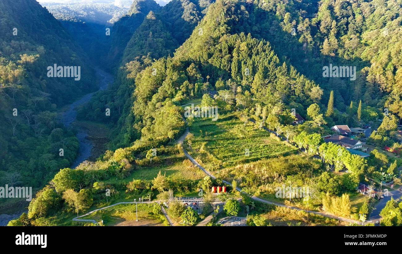 Aerial view of Kaliurang in the lush mountainous landscape with dense ...
