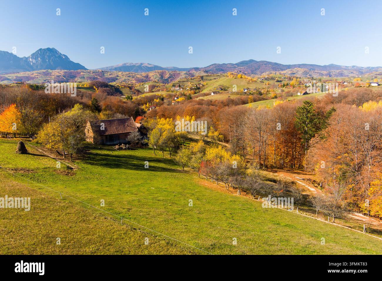 Aerial view of a rustic house nestled in a vibrant autumn landscape ...