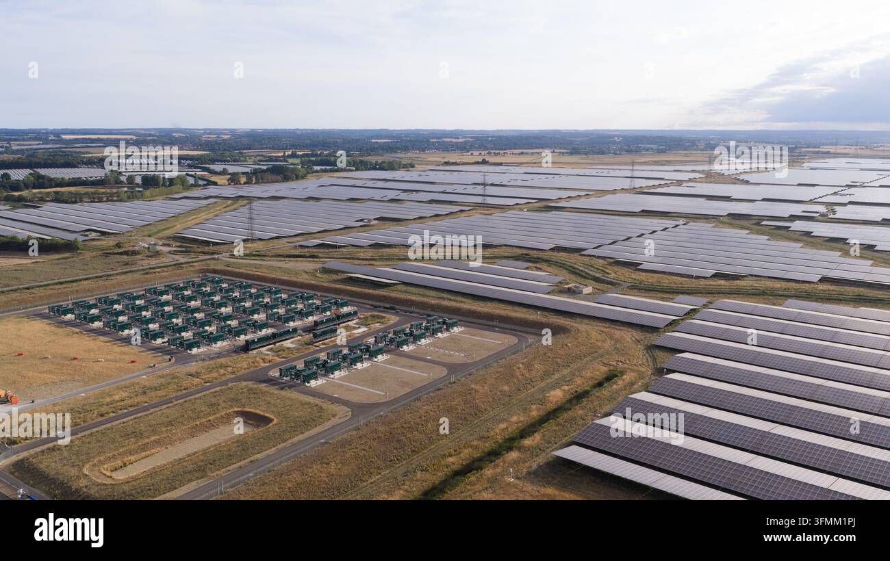 Aerial view of a vast solar farm with rows of photovoltaic panels and ...