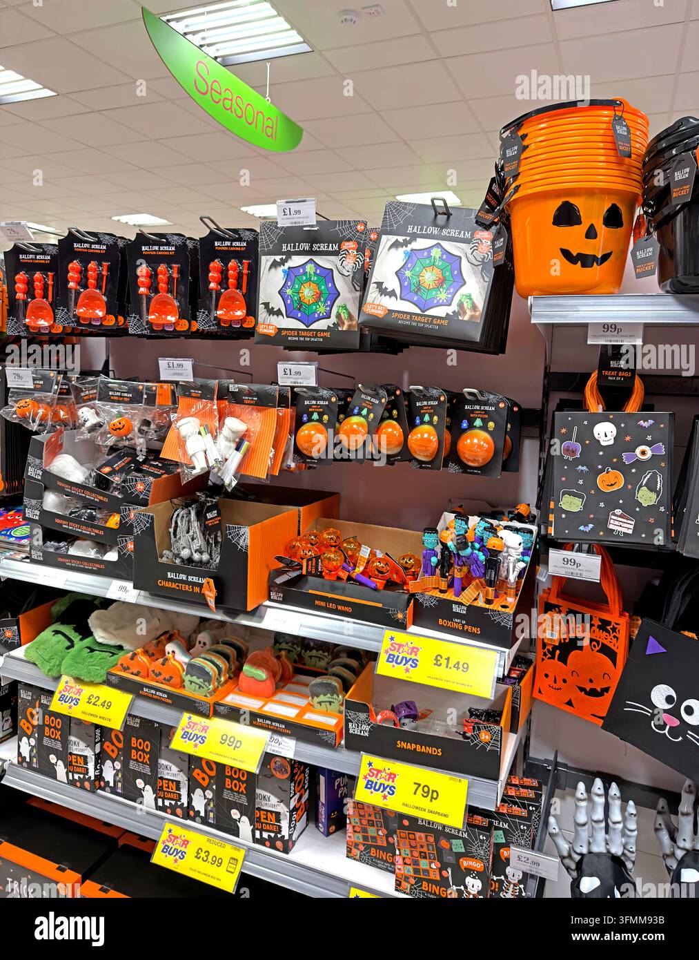 Supermarket seasonal Halloween aisle with pumpkin decorations, masks and orange-and-black merchandise. Stock Photo