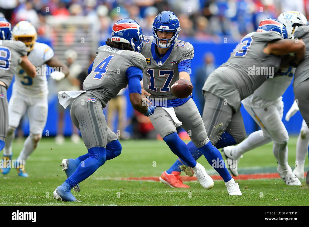 Buffalo Bills quarterback Josh Allen (17) hands off to running back ...