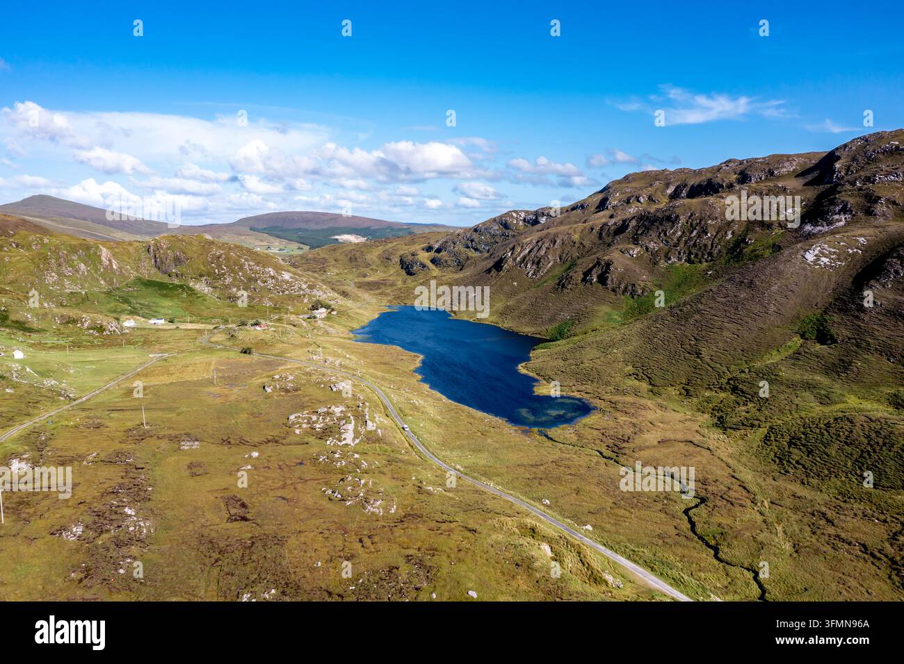 Aerial view of An Port lake surrounded by rugged mountains, green hills ...