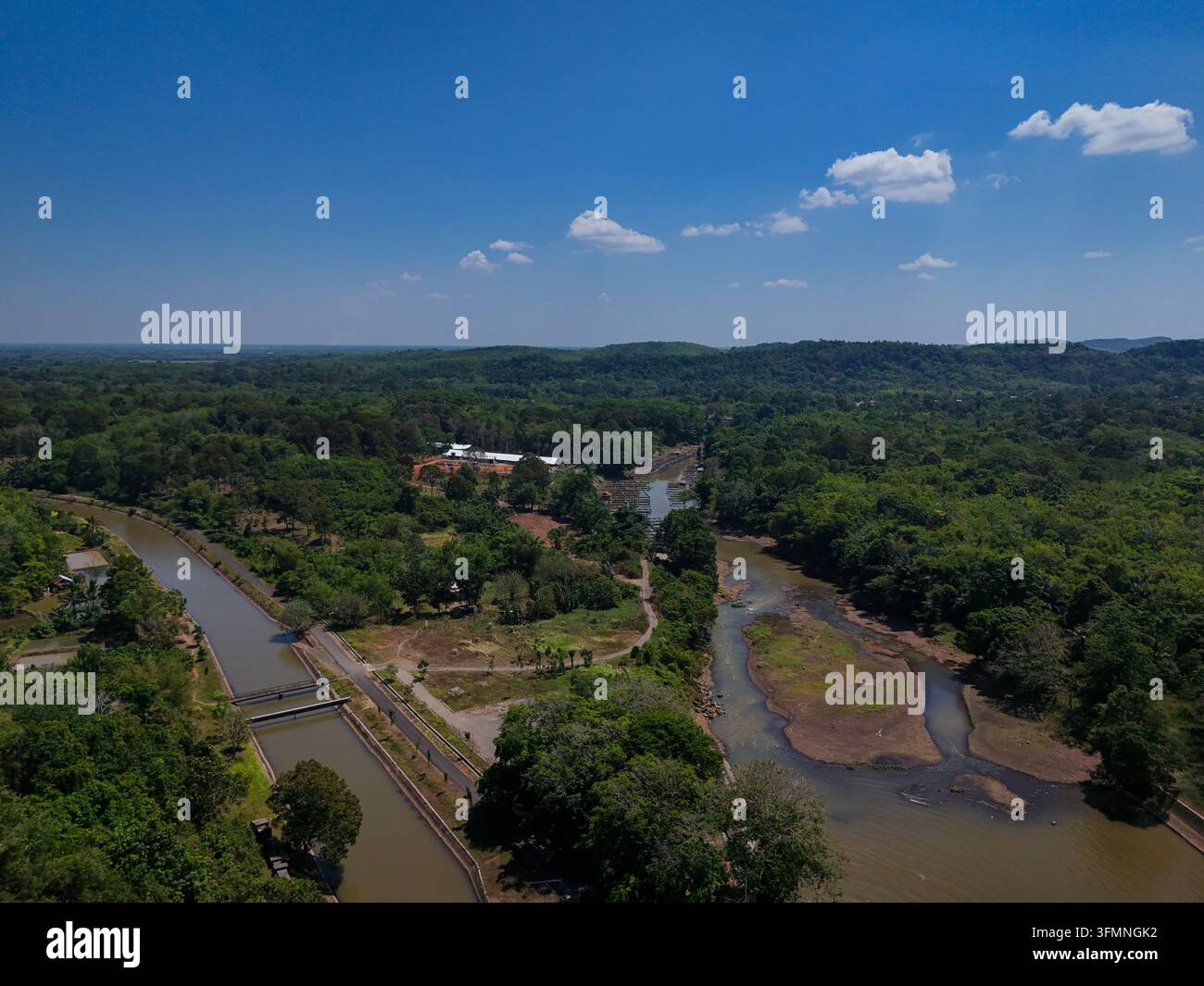 Aerial view of a river flowing through a lush tropical landscape with ...