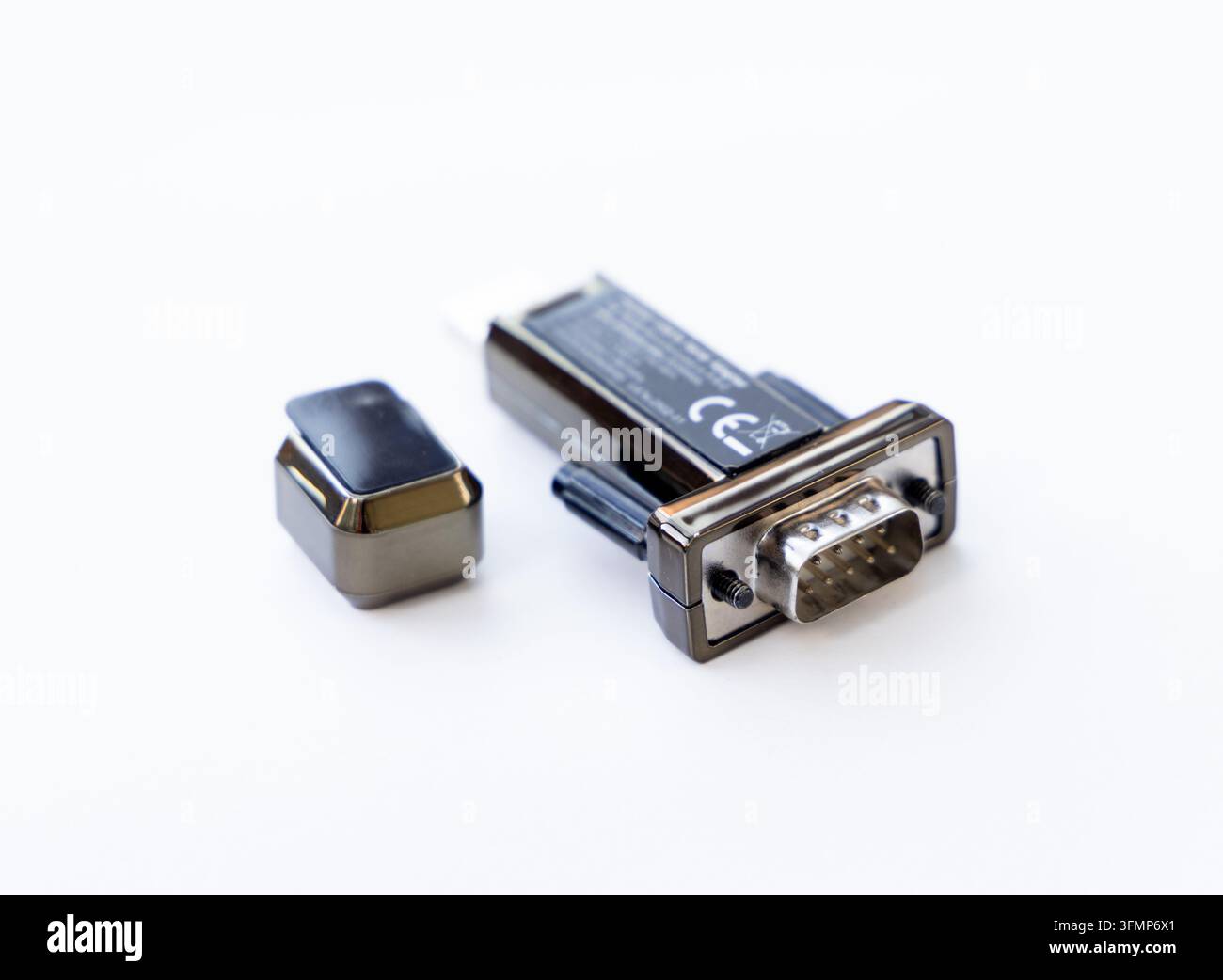 An electronic serial adapter connector rests on a white background Stock Photo