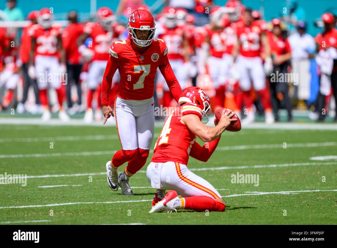 Kansas City Chiefs punter Matt Araiza (14) holds the ball as kicker ...