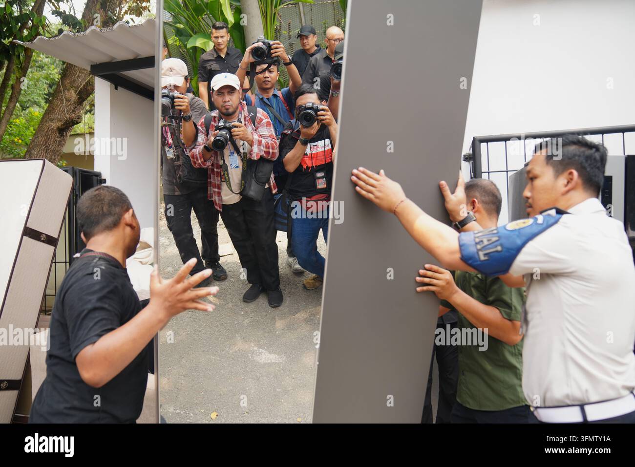 Workers remove furniture from a controversial luxury compound inside a ...