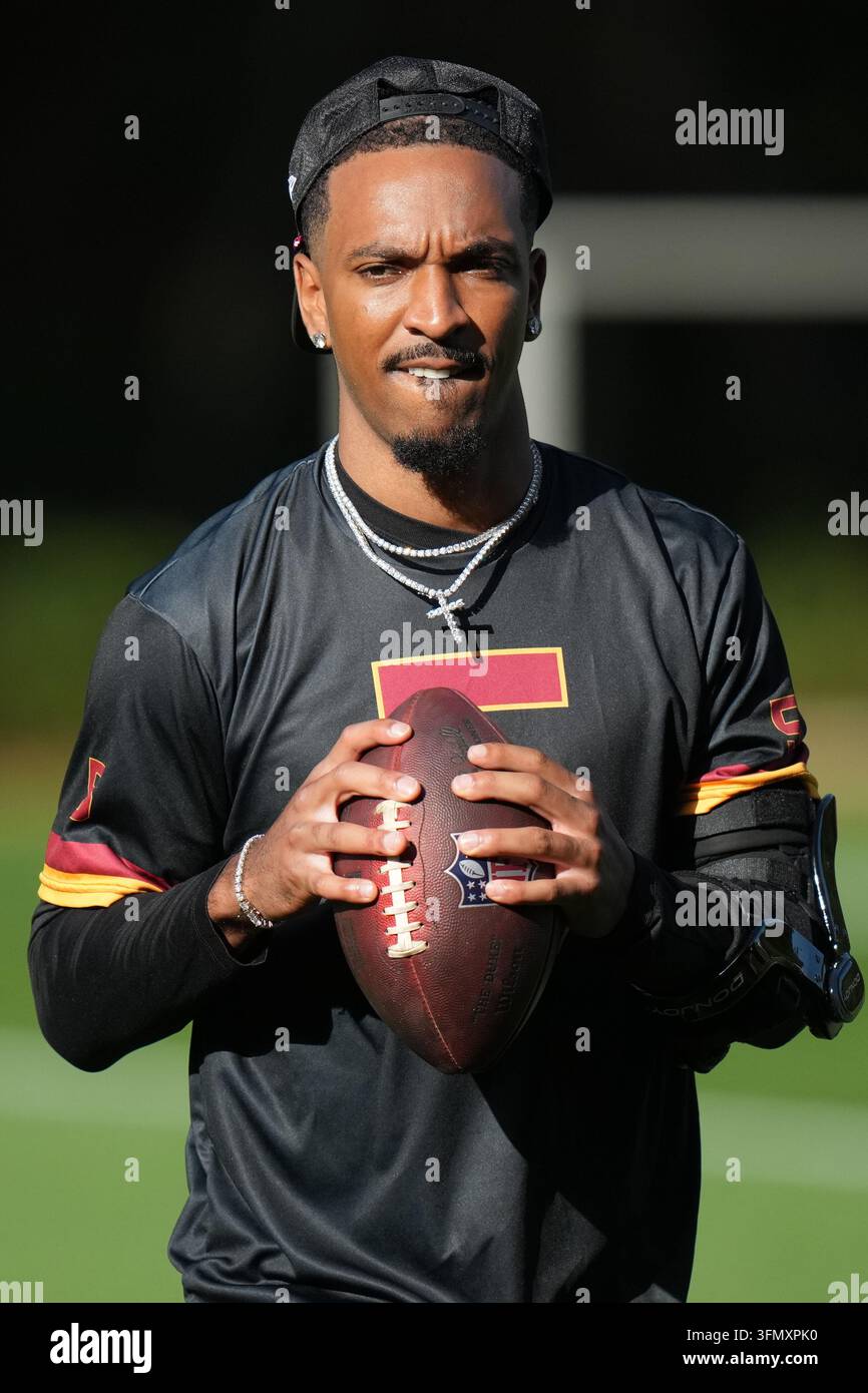Commanders Vector Washington Commanders quarterback Jayden Daniels (5), takes part in a ...