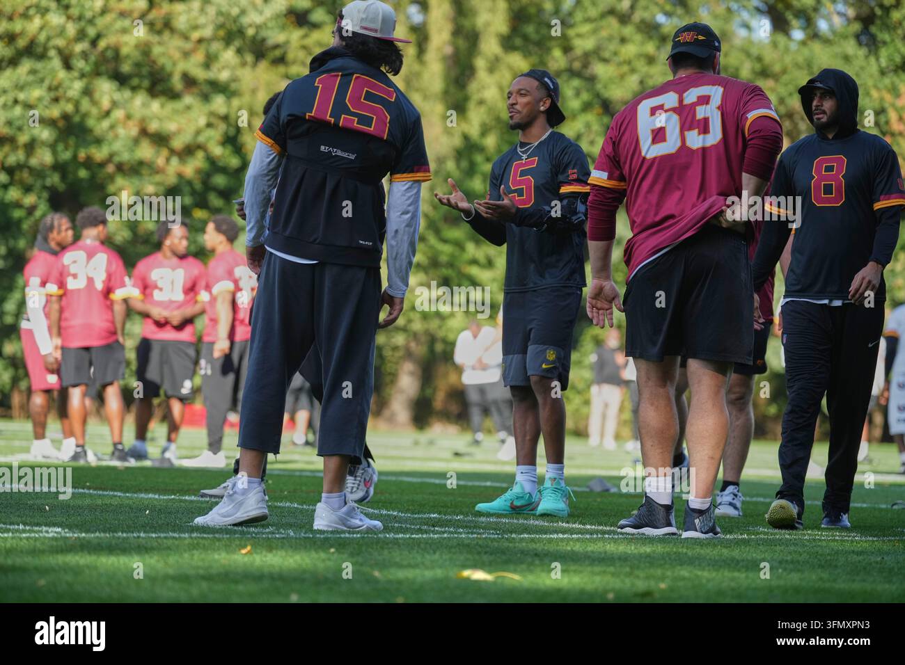Commanders Vector Washington Commanders quarterback Jayden Daniels (5), center, takes ...