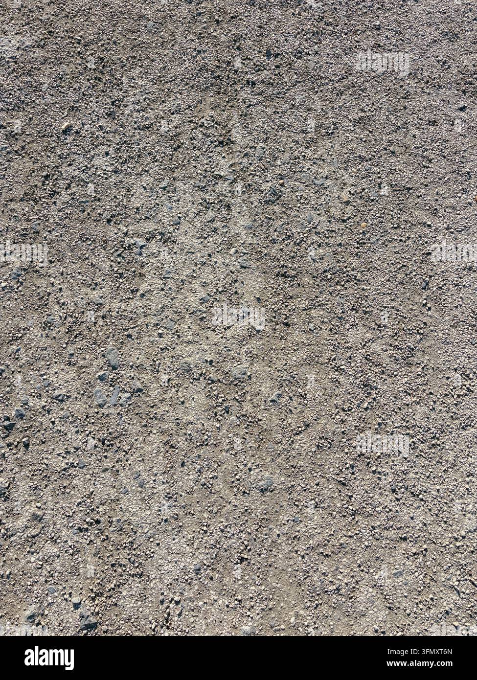 Rough gray asphalt surface texture with small pebbles and weathered detail Stock Photo
