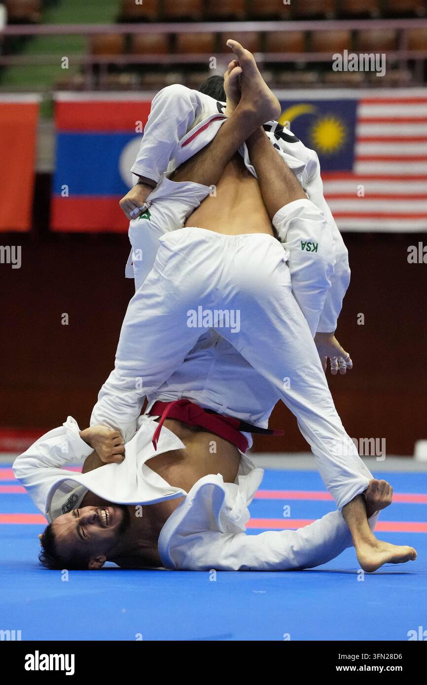 Singapore's Noah Tian Run Lim, top, competes against Saudi Arabia's ...