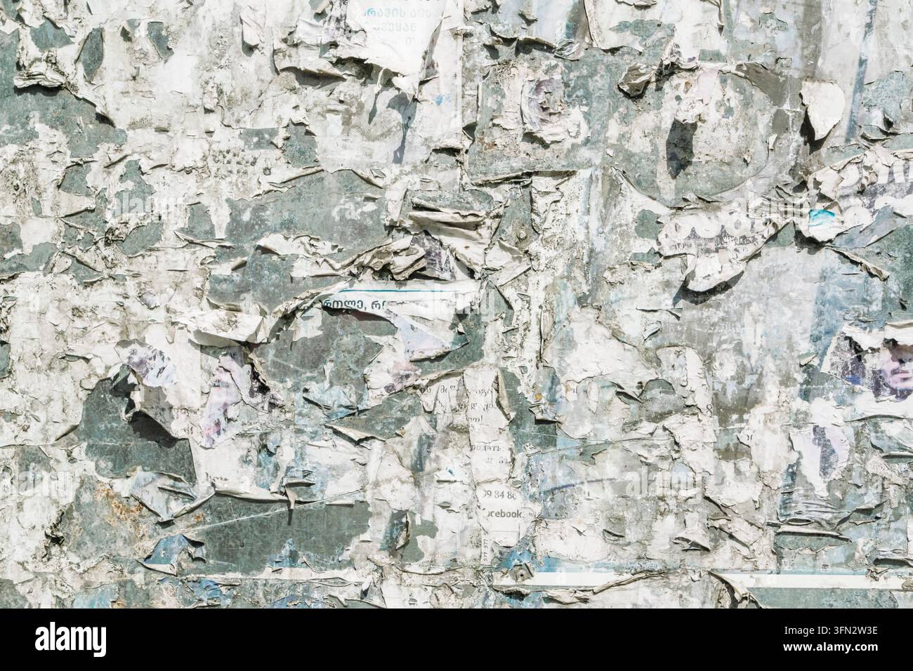 Grungy torn paper texture, weathered street poster wall, distressed bulletin board background. High quality photo Stock Photo