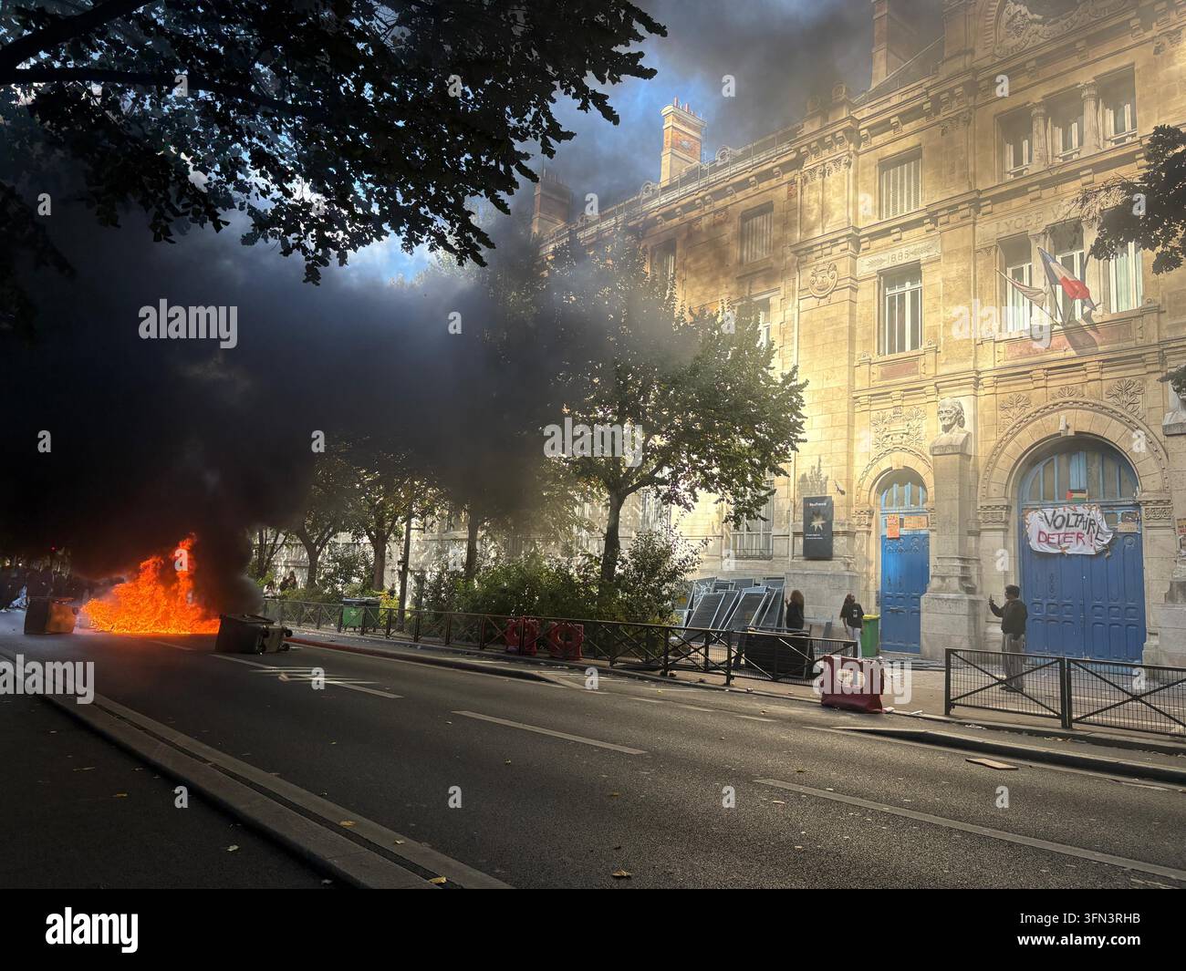 In this photo taken with a smartphone, high school students burn ...