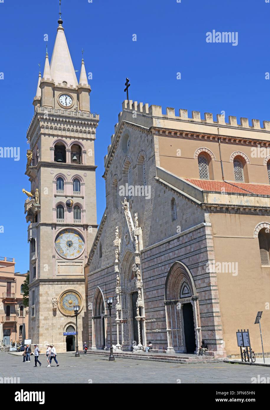 Messina Cathedral and astronomical clock tower in Piazza Duomo, Sicily, under a clear blue sky. Stock Photo
