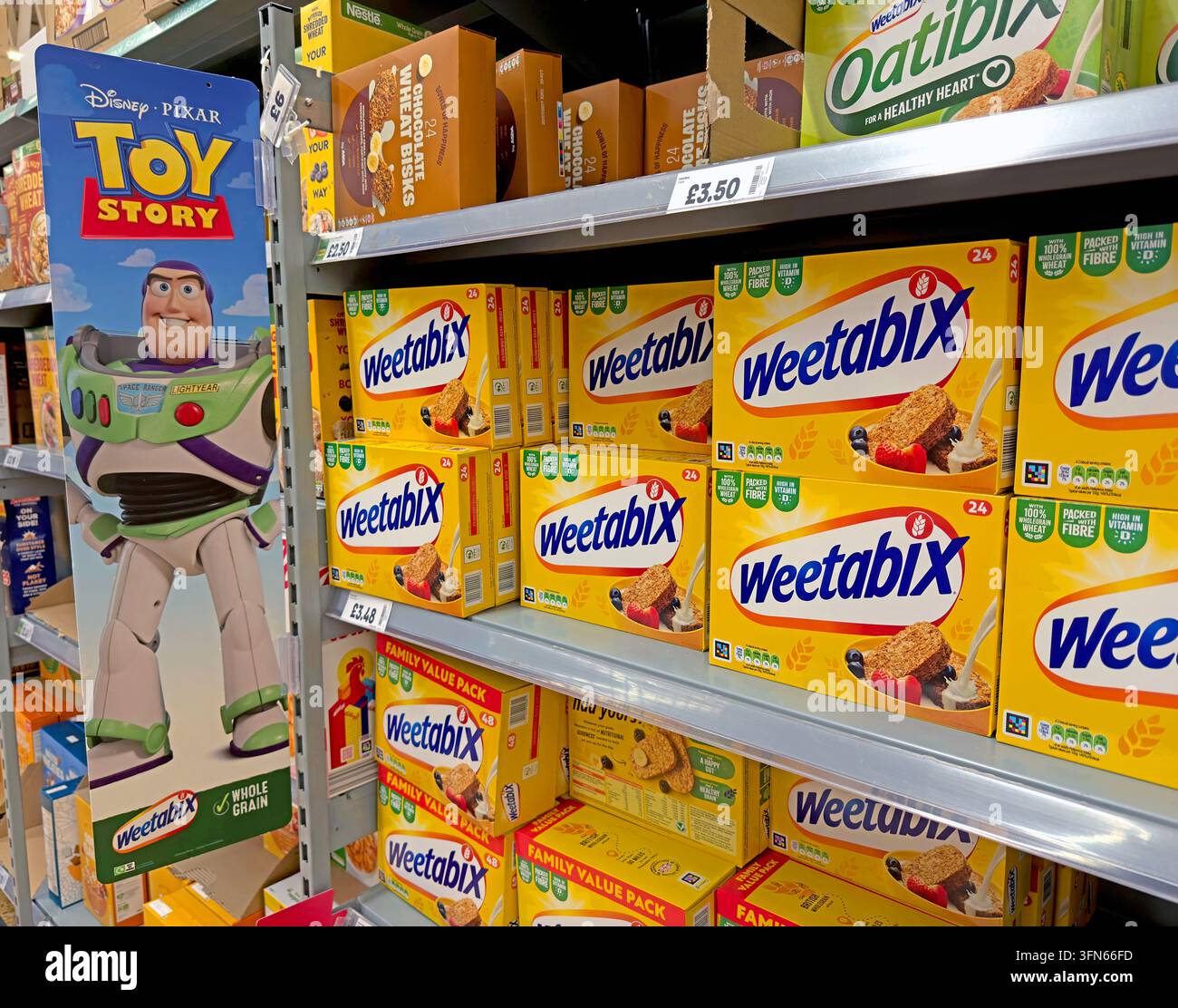 Weetabix cereal aisle with Disney Pixar Toy Story promotion in a UK supermarket, showing branded grocery marketing. Stock Photo