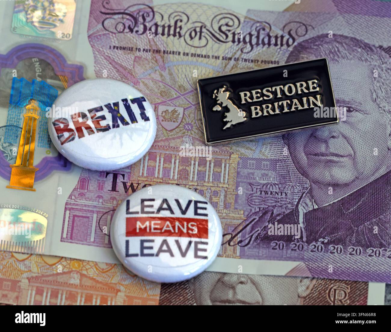 Restore Britain and Brexit badges on sterling banknotes, illustrating right-wing political funding and Rupert Lowe's party. Stock Photo