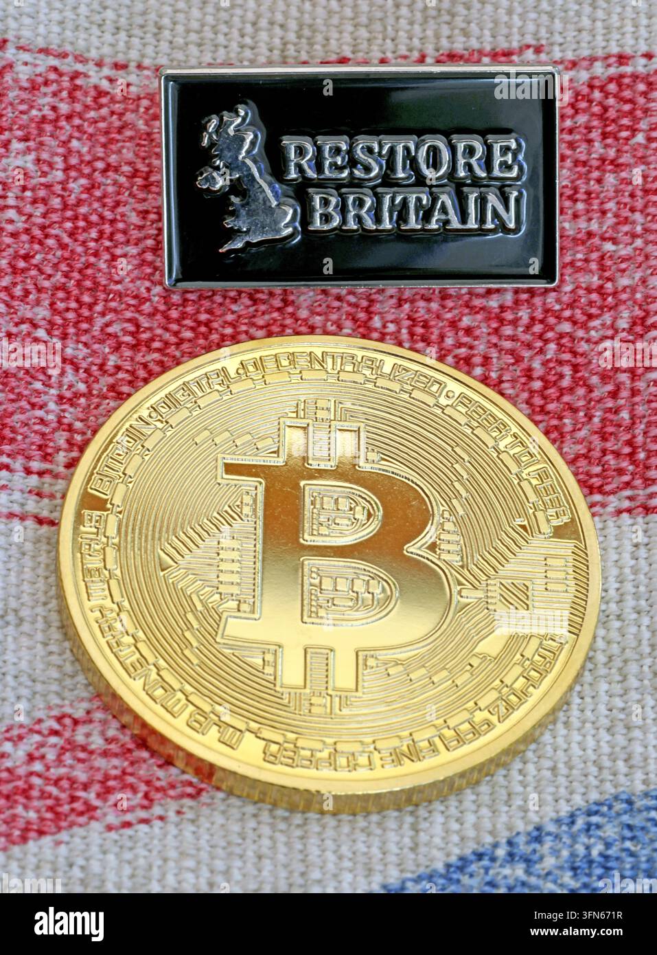 Restore Britain badge with Bitcoin token, illustrating UK political funding and crypto-donation debate. Stock Photo
