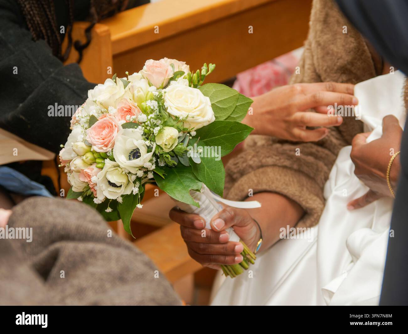 Close-up of wedding bouquet held by a person in a ceremony setting. Stock Photo