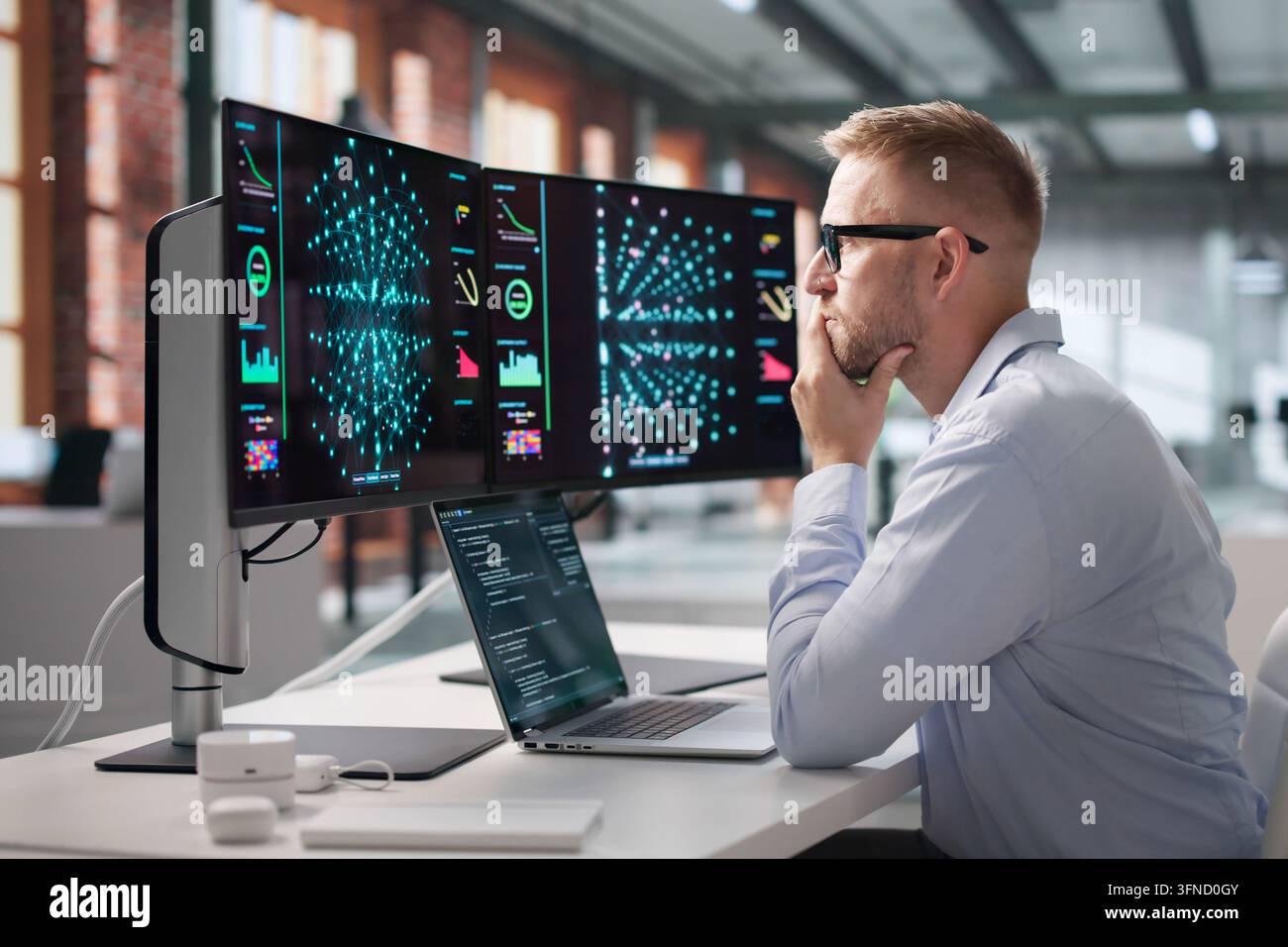 Data Scientist Carefully Codes Neural Network Models On Laptop, Analyzing Data. Stock Photo