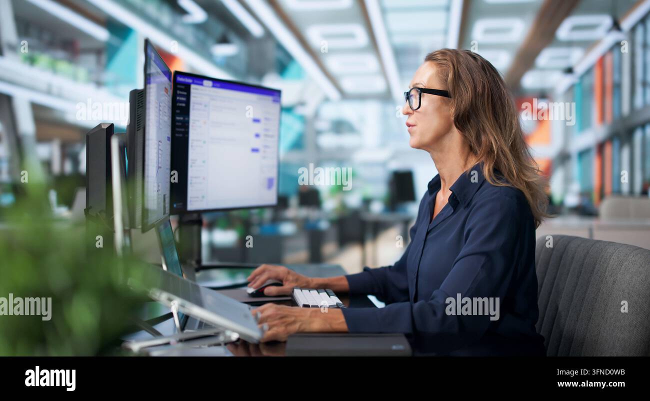 Customer Support Specialist Efficiently Manages AI Chatbot Software On Laptop. Stock Photo