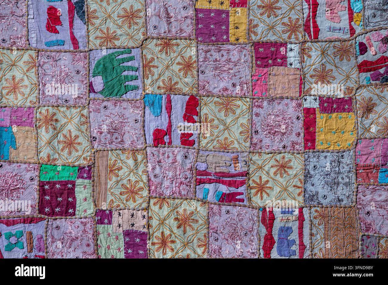 Detail old colorful patchwork carpet in background, India. Close up Stock Photo