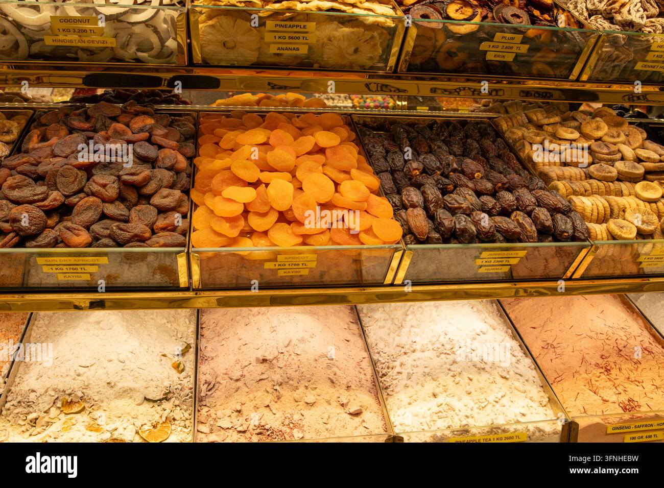 Assorted Dried Fruits Displayed in Glass Containers at a Food Market Stock Photo