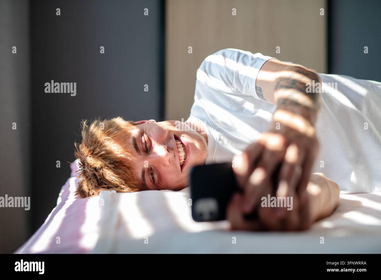 Man in love texting to his partner. Stock Photo