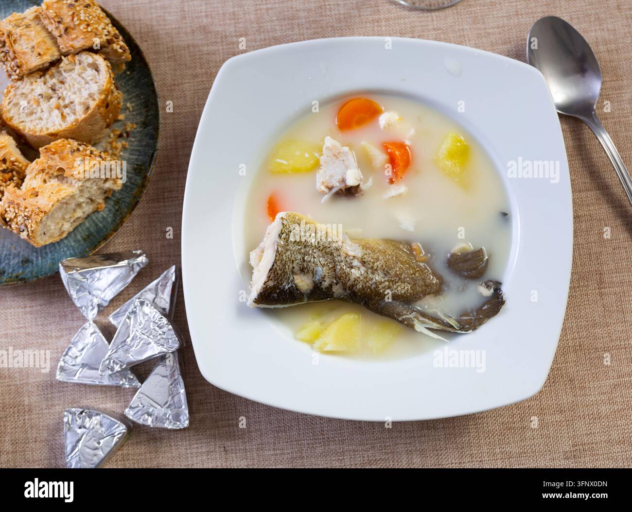 Delicious cod and cheese soup, creamy and warming, served in deep bowl ...