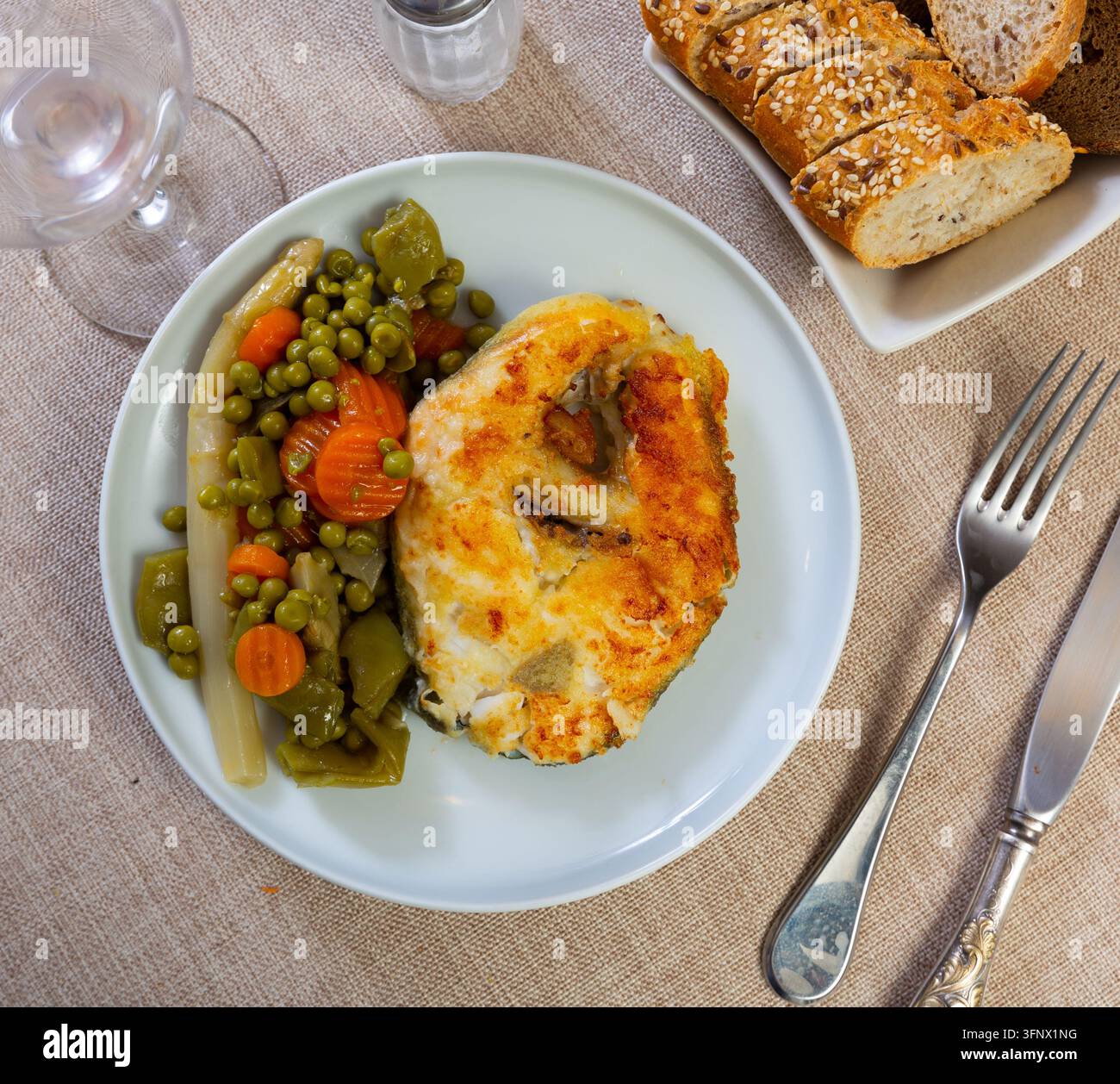 Plate of bacalhau (salted cod) fillet served with portion of stewed ...