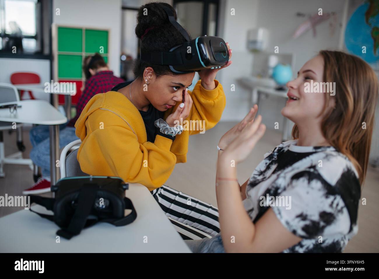 High school student using virtual reality for immersive learning in classroom. Stock Photo