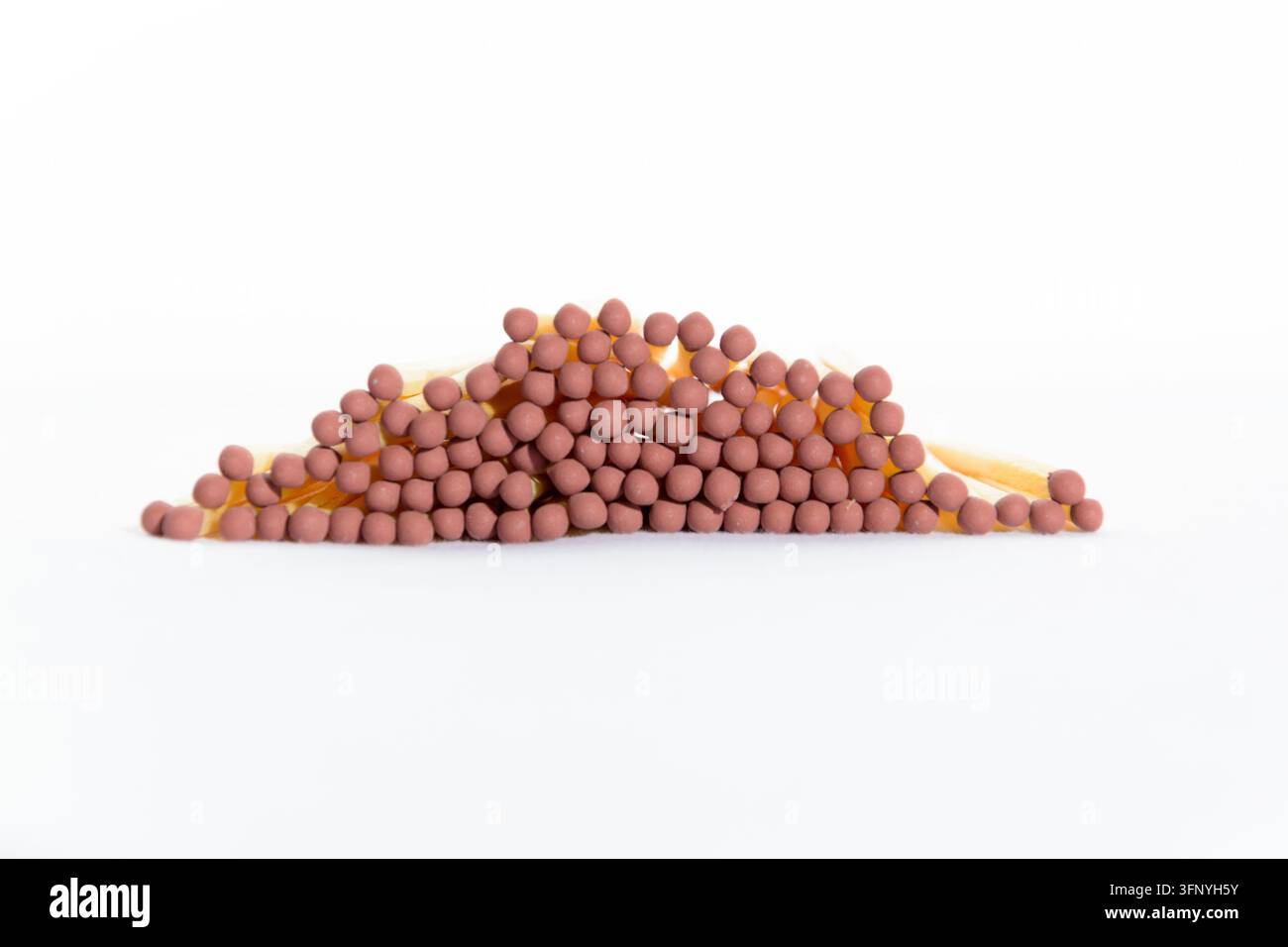 Close-up front view of a stack of new unused wooden matches with brown ...