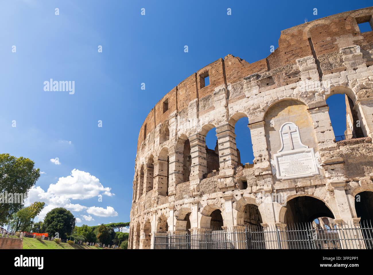 View of the Colosseum with its iconic stone arches and weathered facade ...