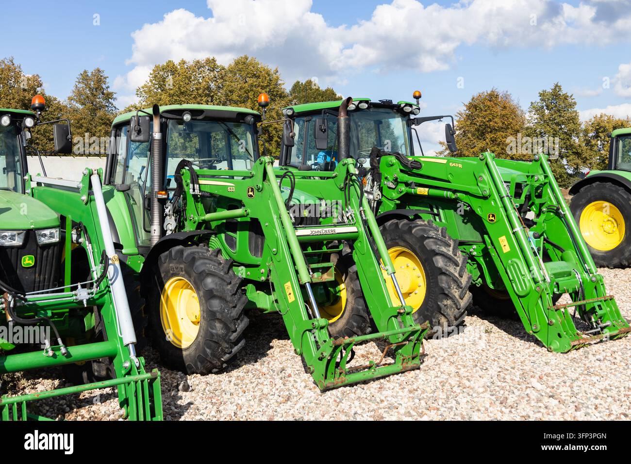Agricultural tractors with front loaders on a farm lot. Kaunas, Lithuania, 28 September 2026 Stock Photo