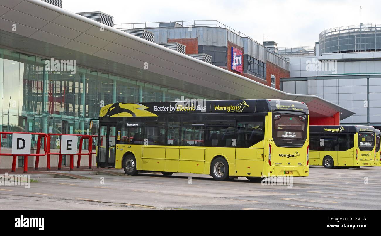 Warrington's Own Buses vehicles stand at the town centre bus interchange during routine passenger operations. Stock Photo