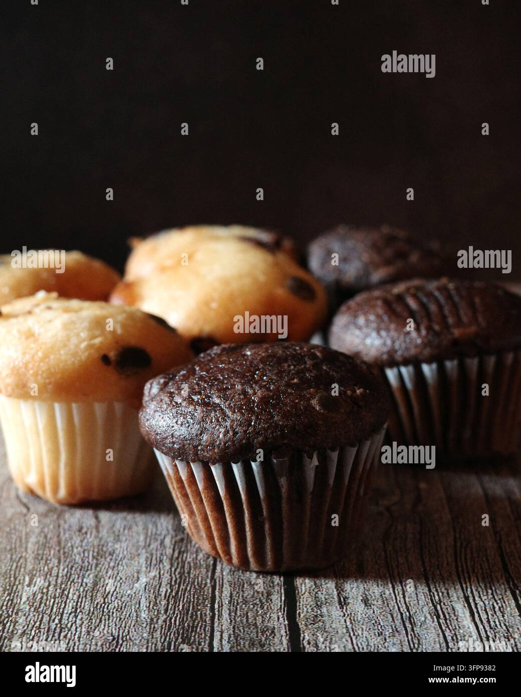 Mini muffins arranged on a wooden background Stock Photo