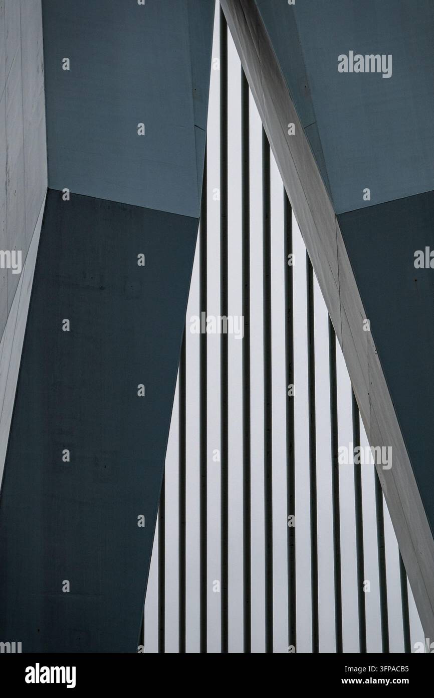 View of abstract modern architectural details featuring sharp concrete angles and vertical metal slats in Rotterdam, South Holland, Netherlands. Stock Photo