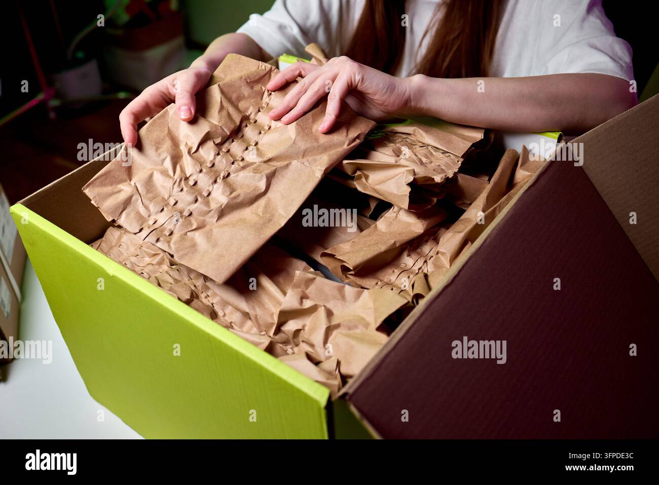 Small Table Paper Hands unpacking crumpled paper inside box. Small business owner ...
