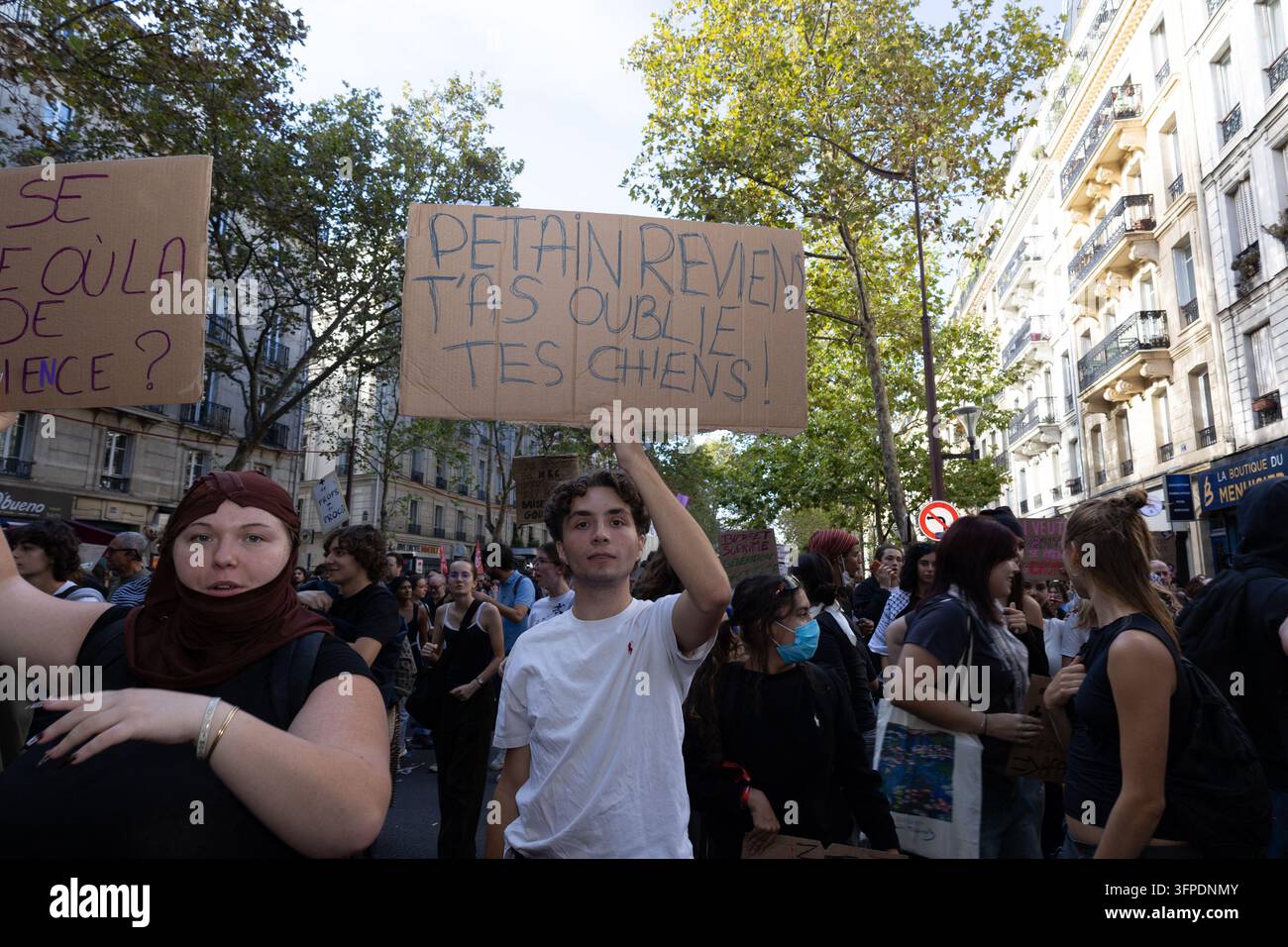 A lycee student holds a protest sign during a demonstration on Place de ...