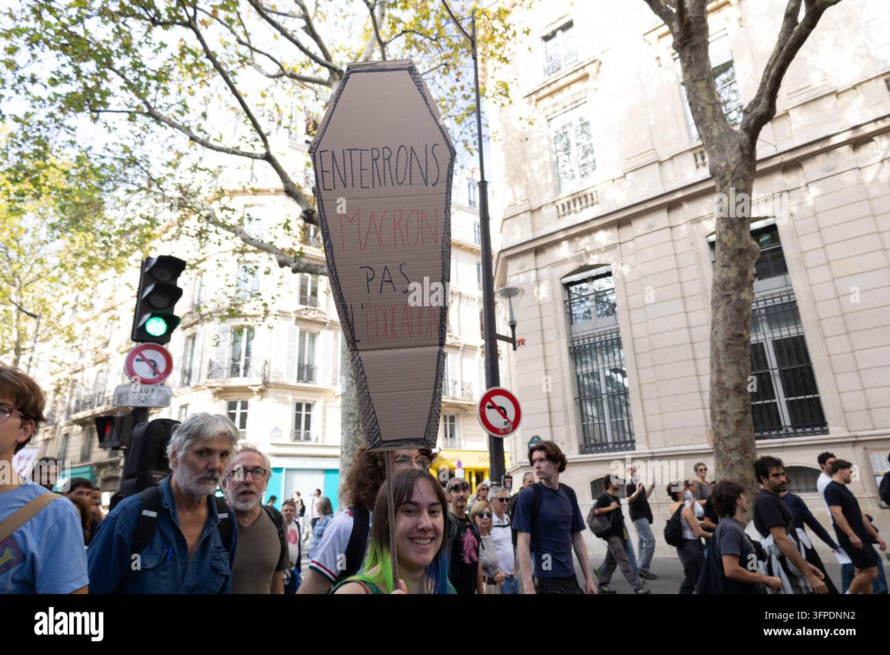 A high school student holds a sign during a protest at Place de la ...