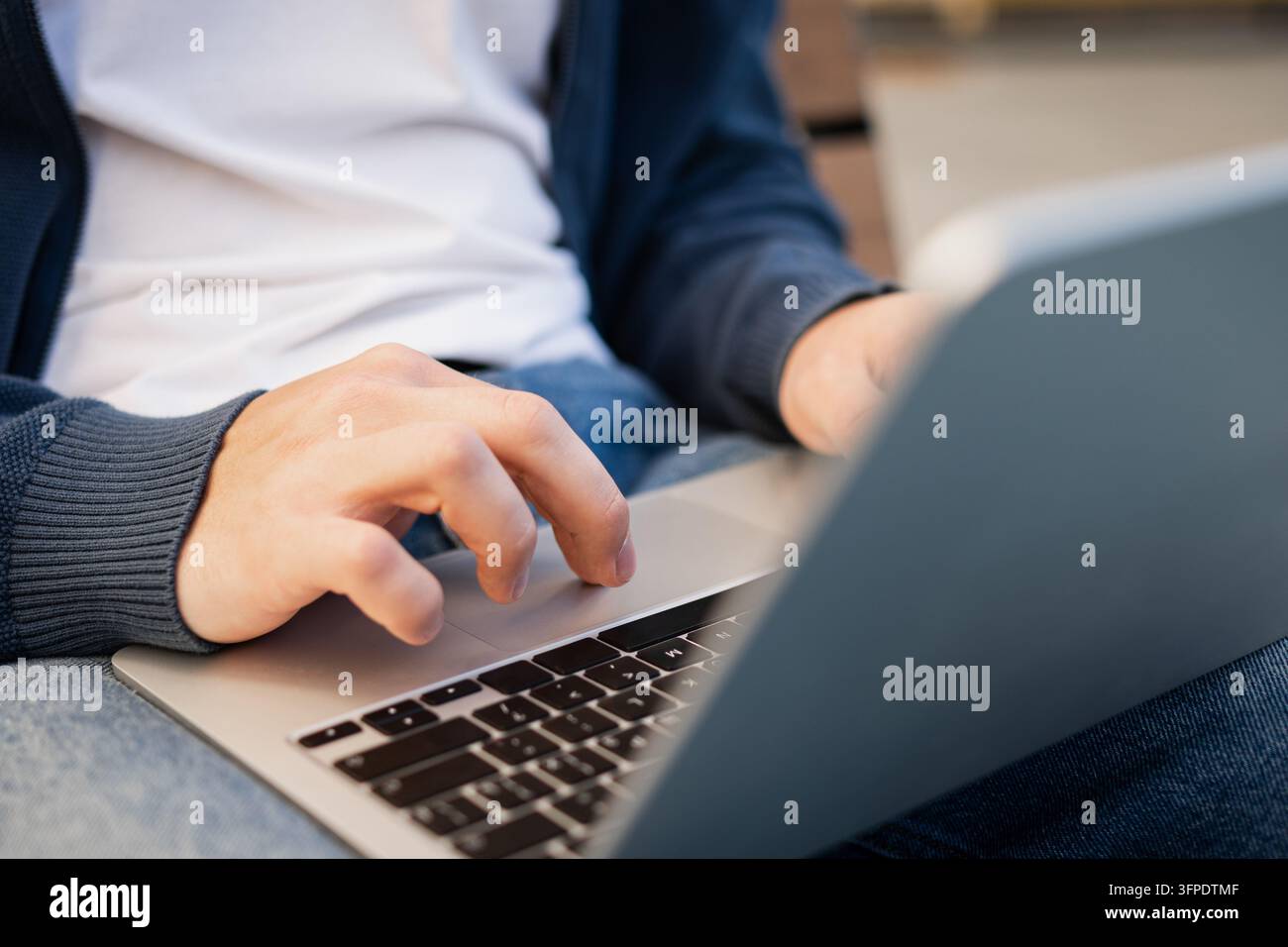 Digital Hand Model Close up of man's hand using a laptop while sitting outdoors, portable ...