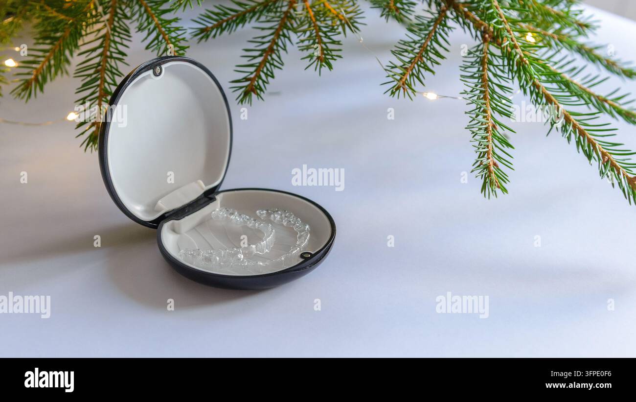 Clear Retyainers Clear dental aligners stored in open orthodontic case under Christmas ...