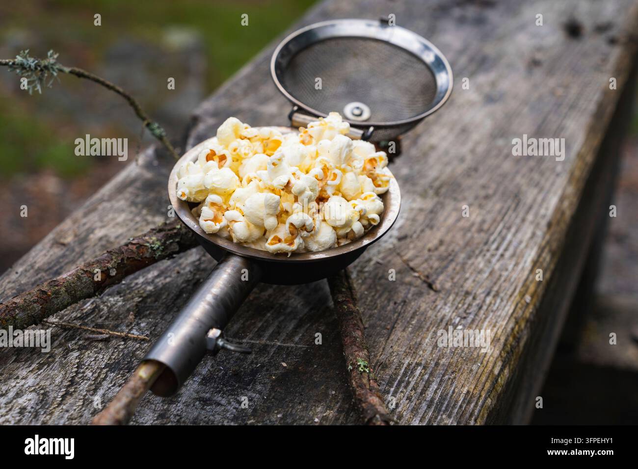 Popcorn made in a popcorn maker, fresh off the campfire. Stock Photo