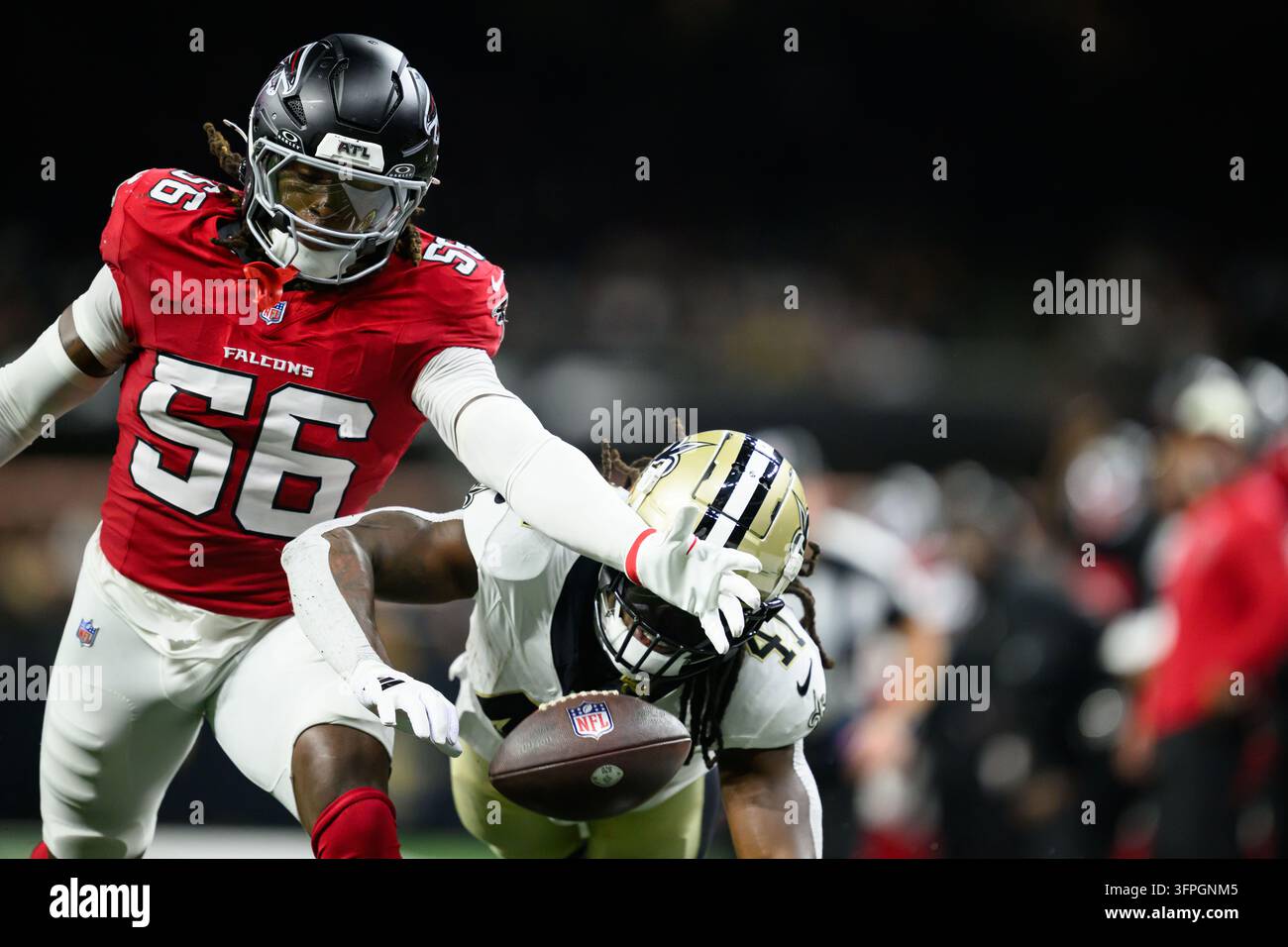 Atlanta Falcons linebacker Harold Perkins Jr. (56), left, blocks pass from New Orleans Saints ...