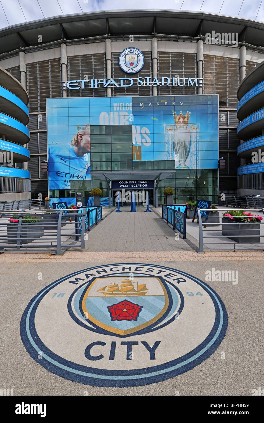 Manchester City club crest displayed in paving at Etihad Stadium visitor entrance Stock Photo