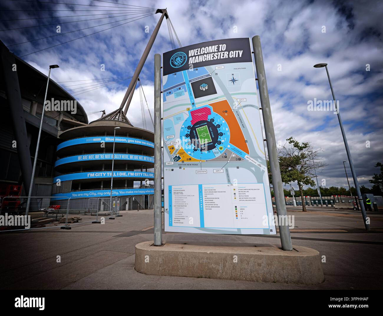 Manchester City Etihad Stadium welcome sign under dramatic cloudy sky Stock Photo