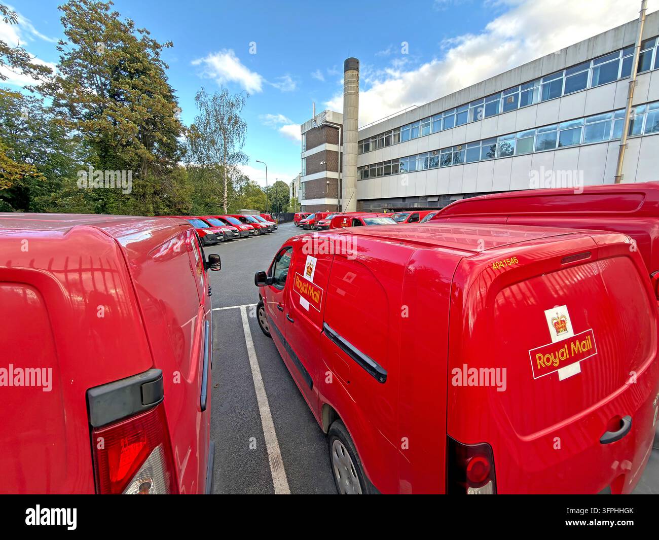 Rows of red Royal Mail delivery vans at York postal depot amid debate about workforce reductions Stock Photo