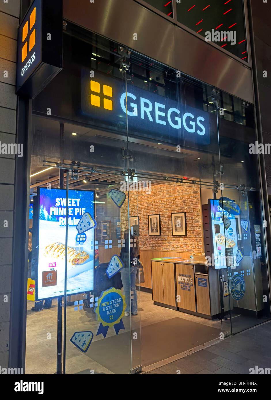 Greggs bakery shopfront illuminated during the evening in Liverpool city centre Stock Photo