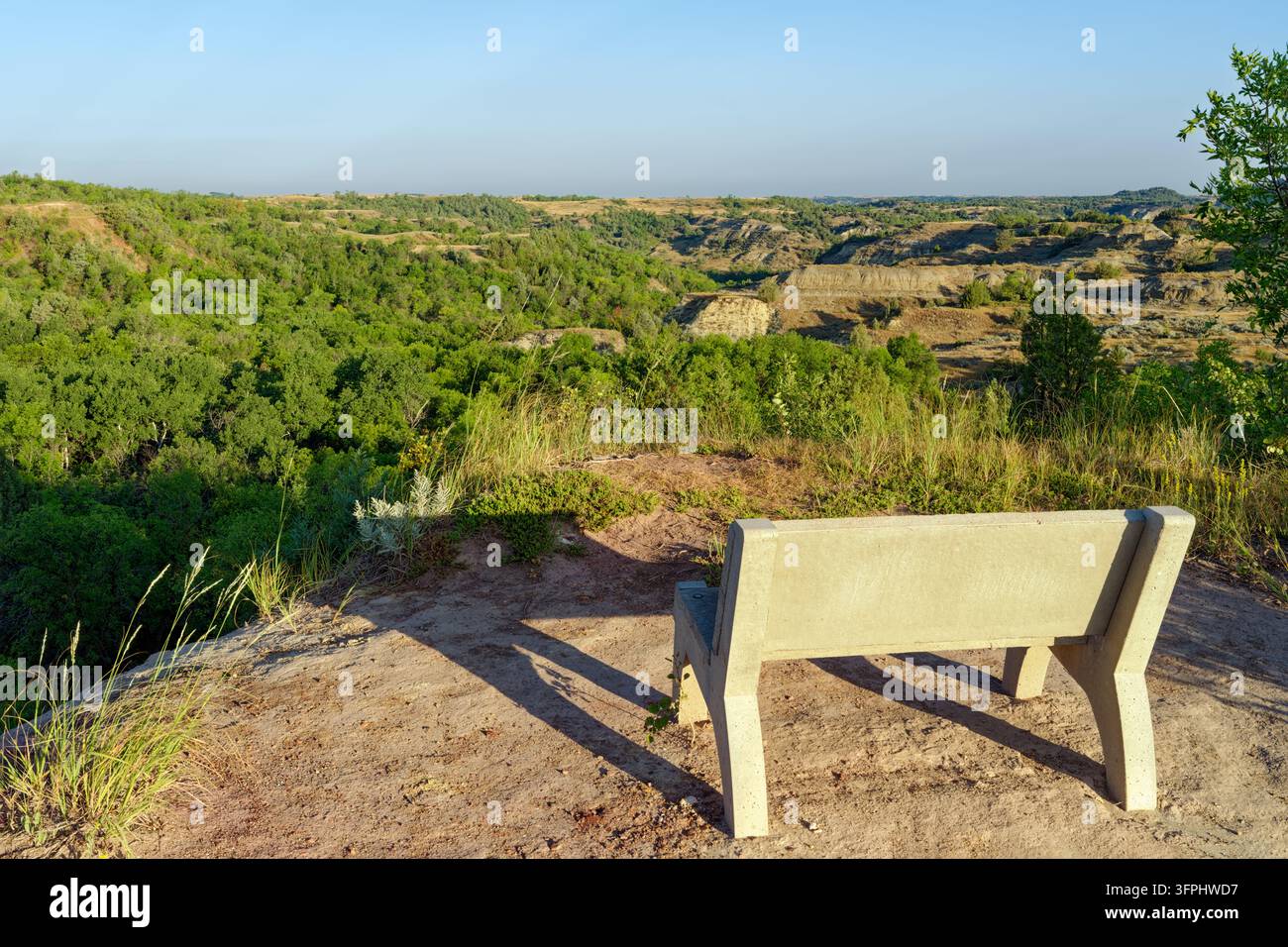 A concrete bench on a ridge overlooking the badlands in western North ...