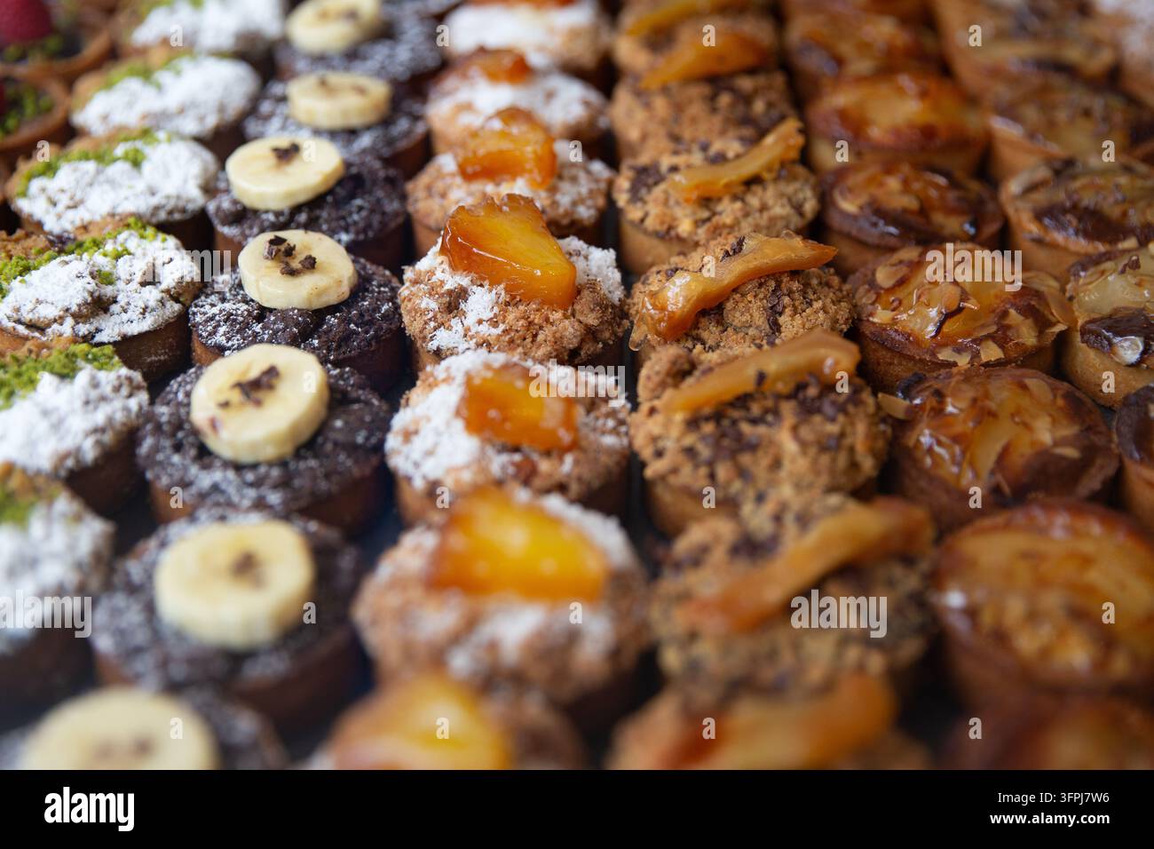 An organized pastry display showcases neat vertical rows of various ...