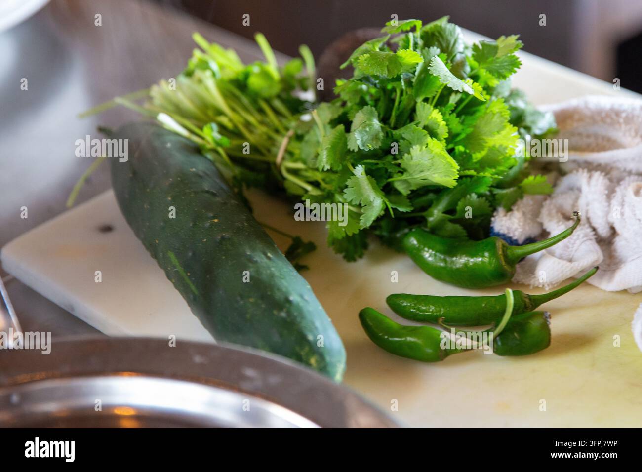 A selection of fresh green cooking ingredients, including a whole ...