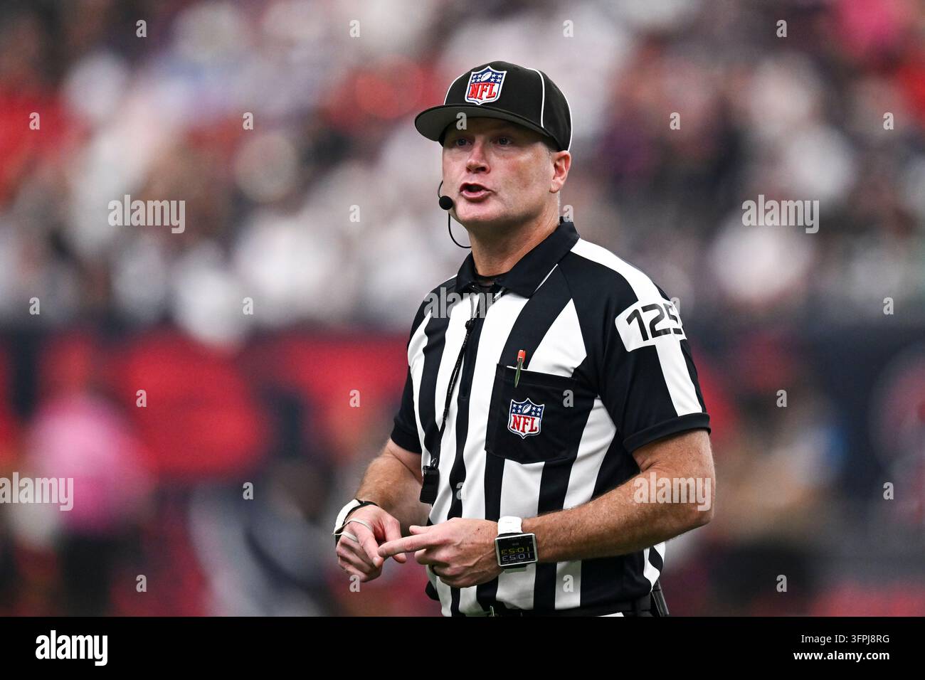 Side judge Chad Hill (125) speaks during an NFL football game between ...